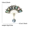 Elegant gold fan brooch with abalone shell, sparkling rhinestones, and a hanging pearl - Gold