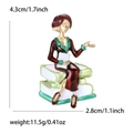 Enamel brooch pin featuring an elegant woman in red dress sitting on books - Purple