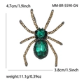 Detail van vintage spinnenbroche 4,7 cm x 3,8 cm met groene edelstenen en stras - Groen