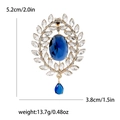 Vintage-Brosche in Gold mit blauem Kristall, ovalem Stein und Tropfenanhänger, 5,2 cm hoch - Blau