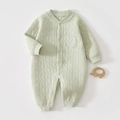 Detail of baby quilted romper with moon and star texture and embroidered baby patch - Thermal Green Star Moon Romper