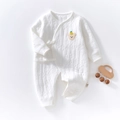 Macro shot of quilted baby romper with cute bear embroidery and side tie fasteners - Size 66 / White
