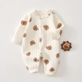 Detail of baby quilted romper showing cream fabric with bear print and ribbed texture - Jiji Bear