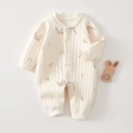 Detailed view of quilted cotton baby romper featuring playful rainbow and bunny prints - Fun House