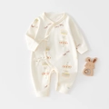 Newborn cotton romper in cream white with colorful carousel print and lace-up closure - Bear Paradise