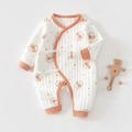 Detail of quilted cotton baby onesie with bear patterns and wooden rattle accessory - Orange Floral Bear / 52cm