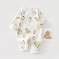 Detail van baby katoenen jumpsuit met dinosaurusprints en zijwaartse striksluiting - Dinosaurus Paradijs / 52cm