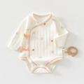 Detail of baby cotton bodysuit with bear patterns and side ribbon ties for newborns - Fruit Tea Bear