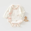 Detailed close-up of baby bodysuit with pink ribbon and cute cartoon bee prints - Floral Leaves
