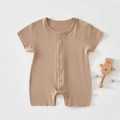 Detail of soft modal cotton baby romper with buttons and a small wooden bear toy - Light Coffee