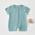 Detailed flat lay of baby short sleeve romper in modal fabric with wood duck rattle - Turquoise Green