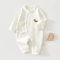 Detail of white cotton baby romper featuring a cute dog embroidery and side-tie closure - Dachshund White