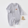 Detail of baby ribbed cotton romper in light purple with house embroidery on grey background - Size 59 / Fog Blue
