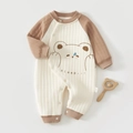 Close-up of baby romper showing quilted fabric texture and cute cartoon bear pattern - Size 59 / Brown Sleeping Bear