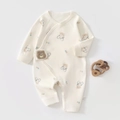 Detail of baby bear astronaut cotton onesie showing snaps and wooden teether - 52cm / Cream Space Bear