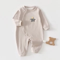 Detailed macro view of pure cotton ribbed fabric and diagonal snap buttons on baby romper - Grey Star / Size 66