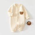 Détail de la maille côtelée et de l'écusson d'ours brun sur la barboteuse pour bébé - Jaune