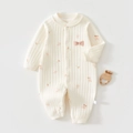 Close-up of quilted cotton baby romper with cherry patterns and snap buttons - Cherry Print