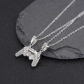 Close-up of magnetic game controller pendant necklaces for couples on a dark stone surface - Silver Pair Stainless Steel Chain
