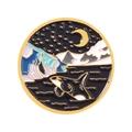 Round enamel badge featuring a killer whale jumping before snowy mountains and night sky - Jumping Orca Style (xz4772)