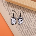 Close-up of music player ghost earrings with cartoon design on vintage book pages - Player Window Ghost Style (EH1518)