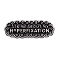 Enamel oval brooch featuring 'Ask me about my hyperfixation' text in black and silver - Black Oval Text Style (xz8928)