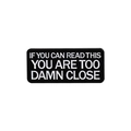 Black enamel rectangular brooch pin featuring white text IF YOU CAN READ THIS YOU ARE TOO CLOSE - Too Damn Close Slogan (QHXZ2765)