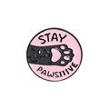 Pink enamel pin featuring a black cat paw with Stay Pawsitive pun text and gold edging - Stay Pawsitive Pink Cat Paw (CC2099)