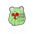 Cute green crying frog enamel pin holding a broken heart with 'HOLD MYSELF CLOSE' text - Heartbroken Style (CC1605)