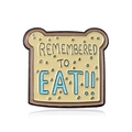 Toast enamel pin featuring blue REMEMBERED TO EAT text on a cream bread slice - Bread Toast Slogan (CC042)
