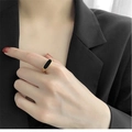 Minimalist gold titanium ring with black oval shell inlay worn by model in black suit - US 6 / Gold With Black Enamel