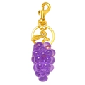 Detailed macro view of purple resin grape keychain with golden metal clasp and leaf charm - Grapes