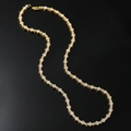 Hip hop style gold tennis necklace with sparkling diamonds on a black reflective surface - Tennis Chain Style / Gold Necklace 18inch