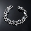 Close-up of silver punk skull chain necklace with white crystals on black background - Silver