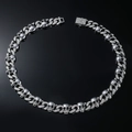 Macro shot of silver skull Cuban chain necklace with sparkling crystals and dark detailing - Necklace (50cm) / Silver
