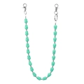 Close-up of matte green skull beads and silver metal spacers on a hip-hop chain accessory - Green