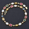 Detail of multi-colored gemstones with micro-pave diamonds on a gold-plated link chain - 24 Inch / Gold