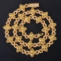 Detailed close-up of golden Cuban chain featuring clover motifs with marquise-cut yellow gems - 20 inch / Gold Green Zirconia