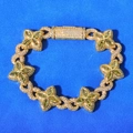 Macro detail of gold Cuban chain bracelet featuring green clover gems and diamond buckle - Bracelet 8 Inch / Gold Green Zirconia