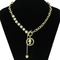 Gold hollow portrait coin necklace with toggle clasp and heart charm on black display - Gold