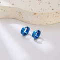 Modern minimalist blue stainless steel hoop earrings for men on textured display - Ear Buckle / Blue