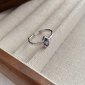 Irregular textured 925 silver ring with marquise blue sapphire in a wooden jewelry tray - Adjustable Open / White Gold
