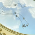 925 silver bow necklace with white pearl and diamonds reflecting blue sky on a mirror - 925 Silver / White Gold