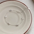 Bracciale in argento S999 con ciondoli a stella marina, conchiglia e fiocco su un piatto - Argento 990 / Argento