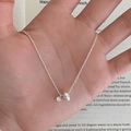 Exquisite S925 sterling silver necklace with zircon pendant held in hand for display - Silver