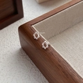 Minimalist S999 sterling silver hollow star stud earrings on a wooden display stand - 990 Silver / Silver