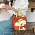 Orange canvas lunch bag with cute white puppy cartoon illustration and yellow handles - Caramel Dog