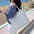 Minimalist white tote bag for women showing a spacious design in an outdoor beach setting - Blank Bag - White