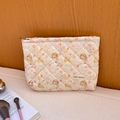 Quilted beige cosmetic bag with cute cartoon prints and secure top zipper closure - Spring Soft Puppy