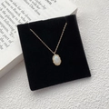 Elegant 925 sterling silver gold necklace with oval iridescent opal pendant on black velvet - Gold